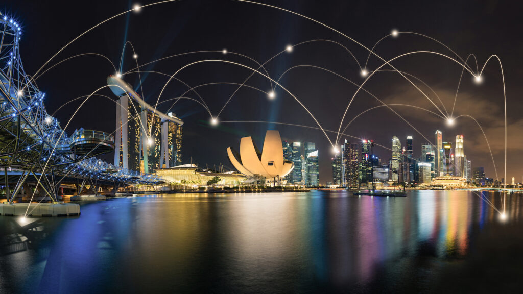 Digital Twin Ideas Travelling from Singapore to the UK Illustration connecting a Southeast Asian city skyline and a UK city skyline with a glowing data line, representing shared urban digital twin approaches